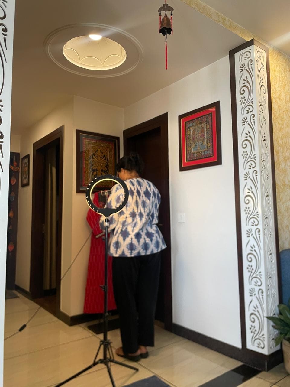 Hema photographing a kurti at home with a ring light
